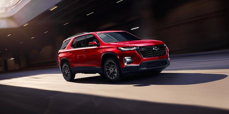 red chevy traverse running on road